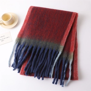 Close-up of knit tassel scarf in red and blue gradient with soft cashmere texture