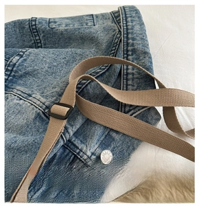 Detail of high-density khaki nylon bag strap with an adjustable matte black buckle
