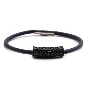 Detailed macro view of dark purple cord bracelet with black embossed metal and silver magnetic clasp