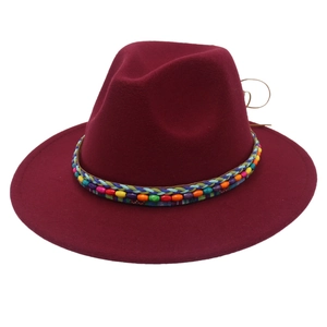 Détail d'un chapeau en feutre bordeaux avec ruban perlé coloré de style bohème