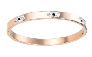 Macro detail of rose gold evil eye bangle with white crystals and hinged clasp