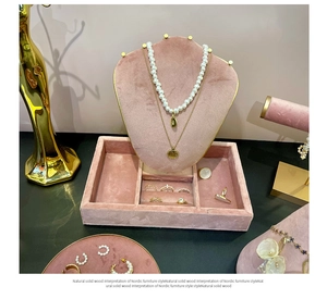 Pink velvet jewelry display set with necklace bust and ring tray with gold trim