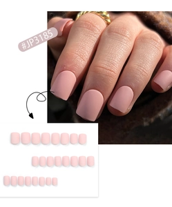 Detailed close-up of matte light pink short press-on nails showing natural texture