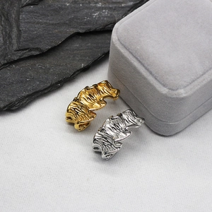 Minimalist irregular wave texture earrings in gold and silver finish on display