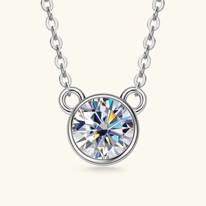 Macro shot of silver S925 necklace featuring a bezel-set round sparkling clear stone