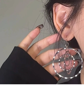 Detail of silver multi-layered hoop earrings with hammer textured finish on a model