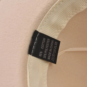Detail view of the hat's inner label showing 65% cotton and 35% polyester material blend