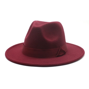 Detail of burgundy wool fedora hat featuring a classic grosgrain ribbon and side bow