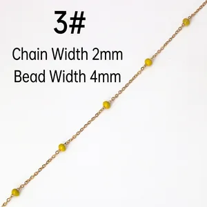 Detail of 2mm gold stainless steel chain with 4mm yellow round beads for DIY jewelry
