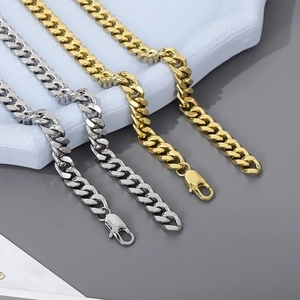 Detailed view of silver and gold Cuban link chains with secure lobster clasps