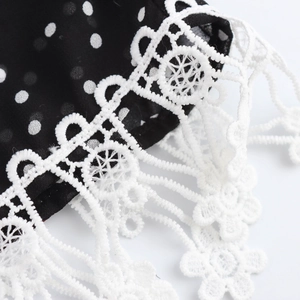 Elegant V-neck polka dot maxi dress featuring refined white lace trim details on black fabric