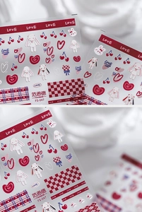Detailed macro view of 3D cartoon nail stickers with hearts, rabbits and cherry patterns