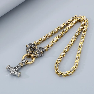 Close-up of Viking Mjolnir pendant with wolf heads and bicolor Byzantine chain