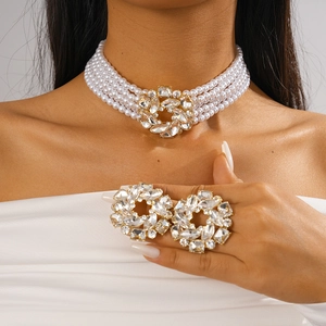 Detail shot of multi-layer pearl choker necklace with rhinestone floral pendant