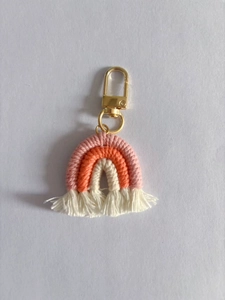 Handmade rainbow cotton tassel keychain with gold metal clasp in pink and orange