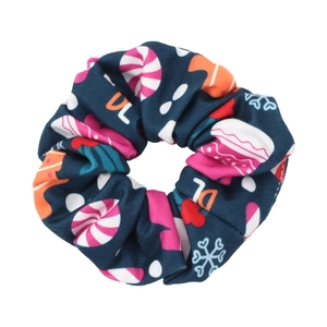 Detailed view of dark blue Christmas scrunchie with candy, snowflake and letter prints