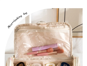 Detail view of large hanging toiletry bag with multiple storage slots and metal hook