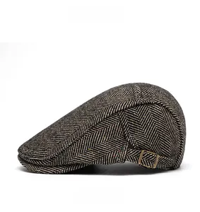 Detail of herringbone wool blend newsboy cap with colorful flecks and metal buckle