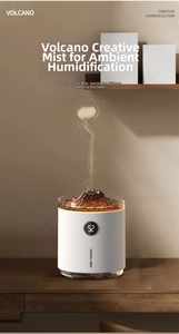 Close-up of volcano humidifier with digital display showing smoke ring spray on wood table