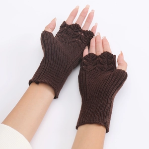 Detailed close-up of dark brown knit fingerless gloves with scalloped crochet edge trim