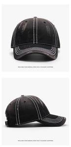 Close-up of black washed denim baseball cap with distressed rips and white contrast stitching