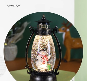 Detail of vintage Christmas water lantern with snowman figurine and glitter snow inside