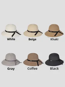 Flat lay of wide brim straw hats in six colors with black ribbon bows for women