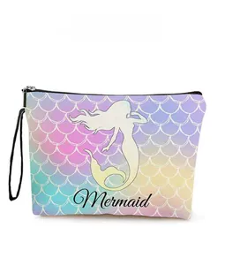Detail of mermaid scale print on zipper pouch with purple and pink gradient colors