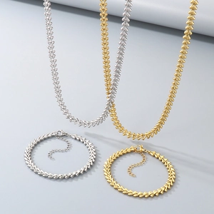 Detail view of 4-piece jewelry set featuring wheat chain necklaces and bracelets in gold and silver