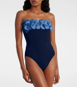 Detail of 3D floral petals on a dark blue one-piece swimsuit with strapless design