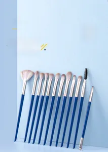 Close-up of 12-piece blue makeup brush set with silver ferrules and gradient bristles