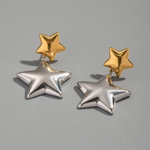 Detailed view of bicolor star earrings featuring polished gold and silver metal finishes