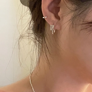 Sterling silver square stud earrings and minimalist ear cuffs shown on a model