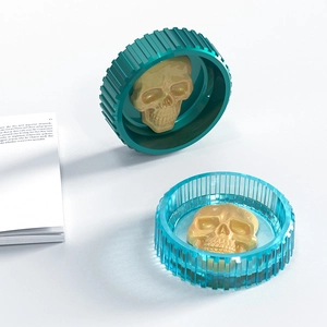 Detail view of gothic resin skull storage boxes in translucent blue and green finish