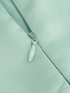 Close-up of the invisible zipper and mint green fabric texture on this sexy evening dress
