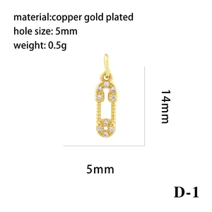 Macro detail of 18K gold plated safety pin pendant with cubic zirconia for DIY jewelry