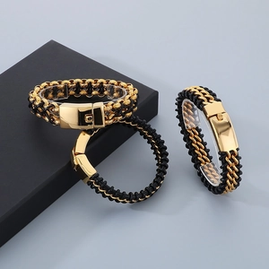 Close-up of dual-row woven leather bracelet with polished gold stainless steel clasp