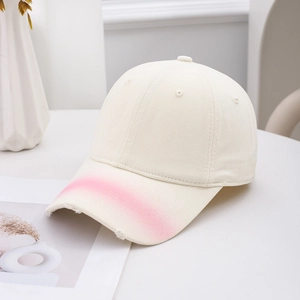 Retro washed denim baseball cap in beige with pink gradient brim and frayed distressed edges