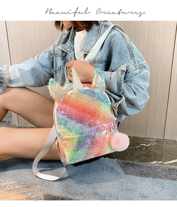 Close-up of a sequin unicorn backpack featuring a pink pompom and silver horn detail