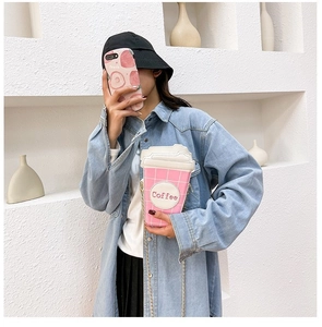 Pink checkered coffee cup shaped crossbody bag with gold chain strap worn by a model