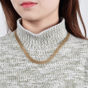 Minimalist wide 8mm gold hollow metal mesh choker necklace worn by a fashion model