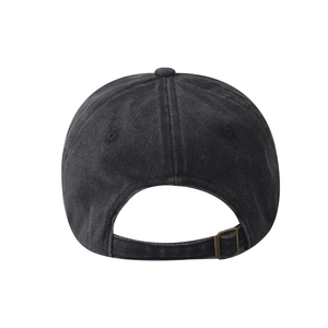 Close-up of vintage black washed cotton baseball cap with adjustable bronze metal buckle