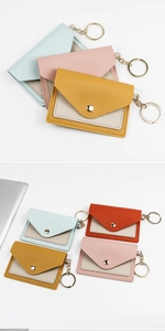 Detail of colorful PU leather envelope card holders with secure metal snaps and keychains