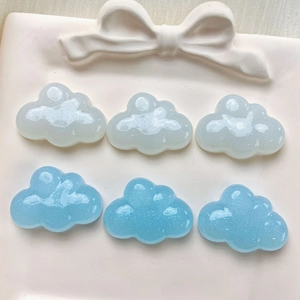 Close-up of glittery blue and clear resin clouds for DIY shoe charms and crafts