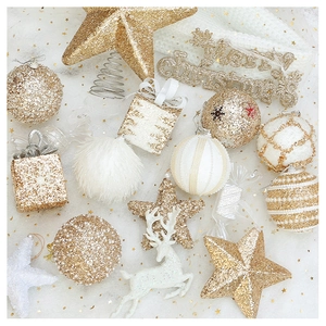 Macro view of champagne gold and white Christmas ornaments including glitter balls and stars