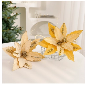 Detail of champagne gold artificial poinsettia flower with sequins in a decorative basket