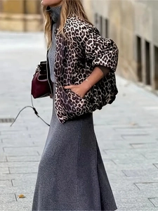 Detail of elegant leopard print reversible jacket paired with a knit skirt on a city street