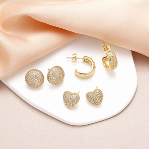 Three-piece gold heart and round stud earrings set with sparkling cubic zirconia stones