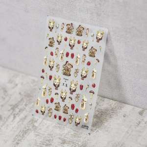 Detail of embossed strawberry bunny nail stickers with vintage mushroom illustration designs