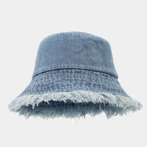 Vintage light blue denim bucket hat with distressed frayed edges in street fashion style